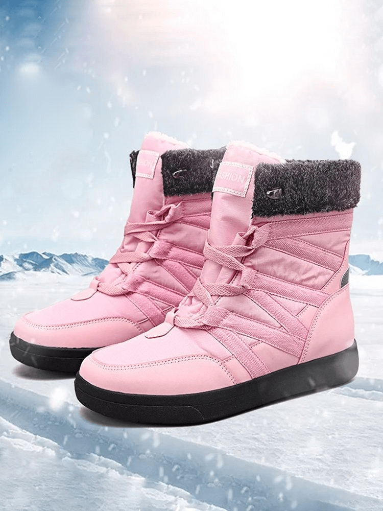 Women's pink non-slip insulated waterproof hiking boots SF1882 on snowy background, with lace-up design and flat heels.